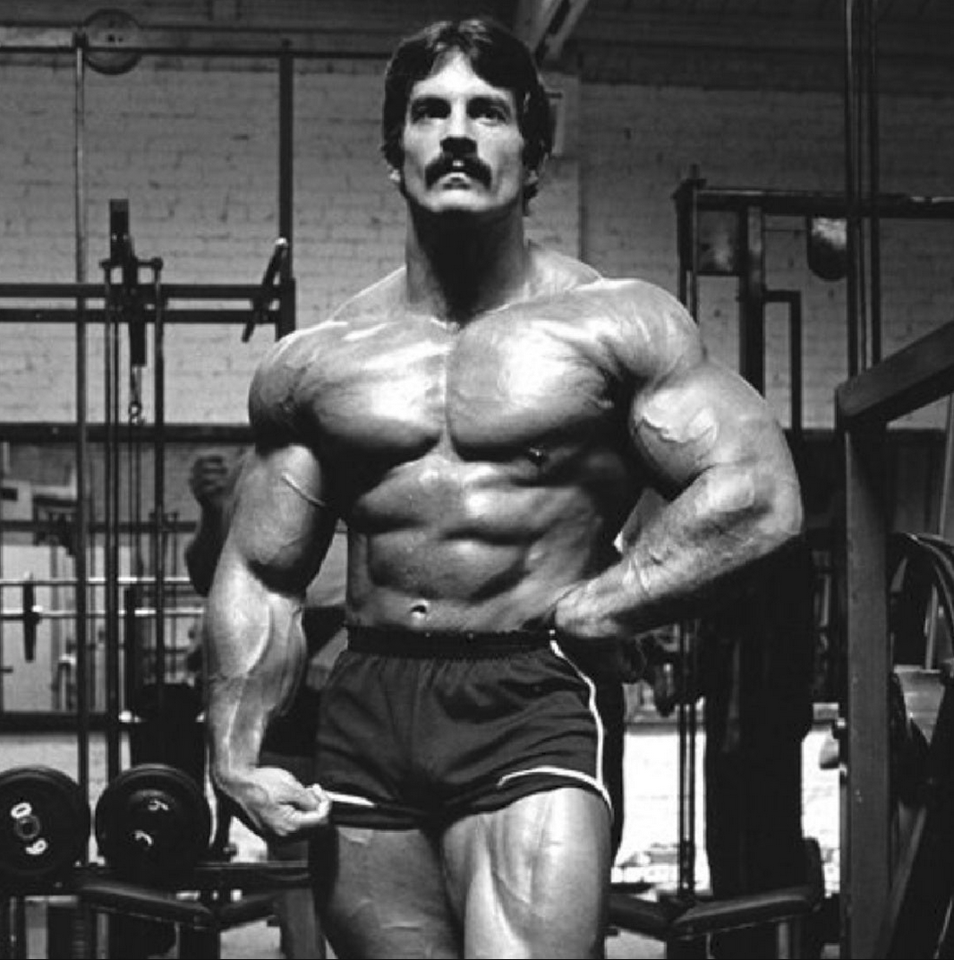 Mentzer standing in the gym