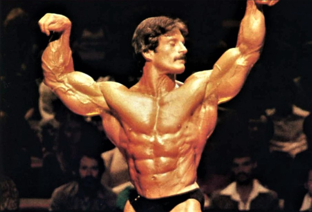Mentzer posing on stage at the Olympia